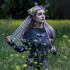 Manicmoth from Germany modeling one of Copper Ashes custom ethically sourced cicada necklaces.